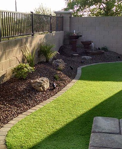 small backyard landscape with synthetic lawn
