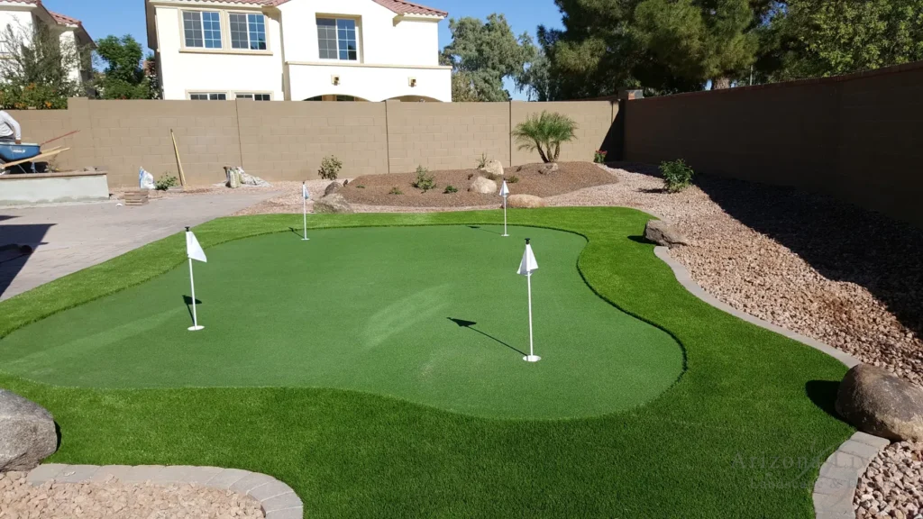 Artificial turf backyard putting green with paver border in Chandler, AZ — installed by Arizona Living Landscape & Design